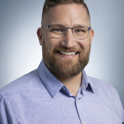 Portrait of Kevin Gordon, marketing technology consultant, smiling in a blue shirt